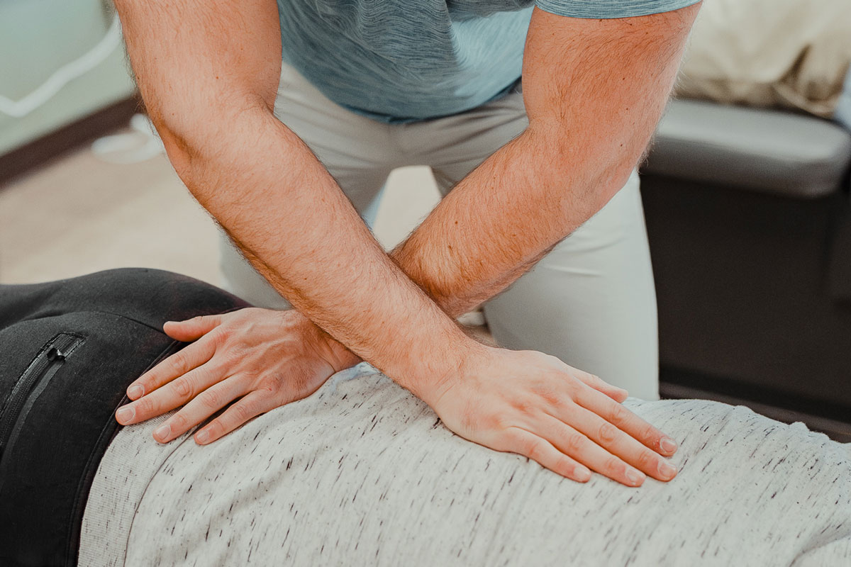 Chiropractor performing a chiropractic adjustment on a man in our Denver chiropractic care clinic