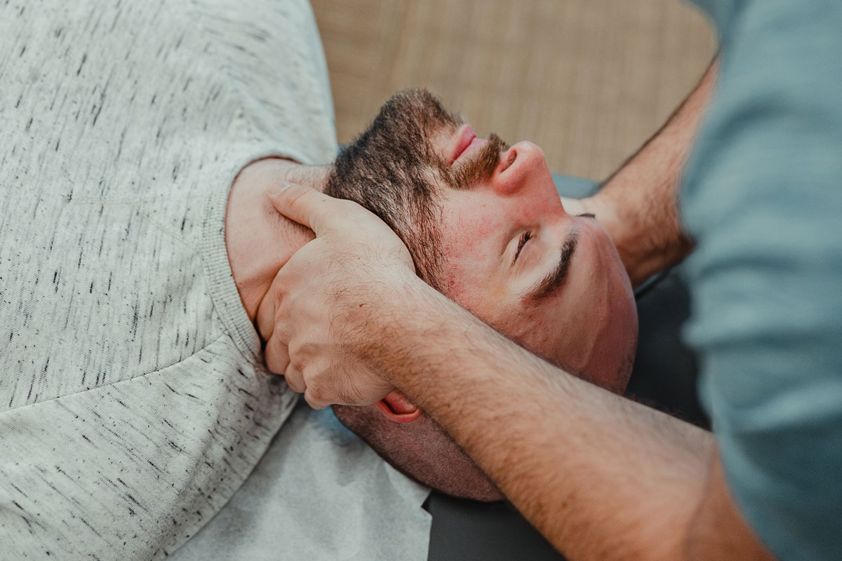 Chiropractor performing a chiropractic adjustment on a man in our Denver chiropractic care clinic